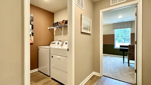 The laundry room is next to the fourth bedroom.