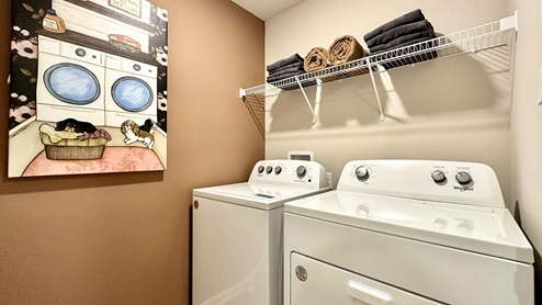 The laundry room comes complete with a washer and dryer.