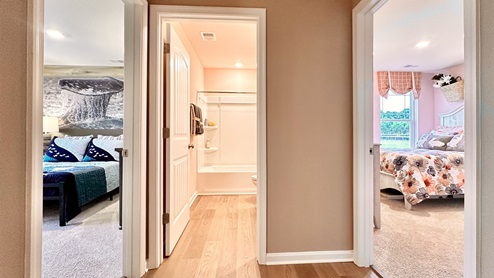 Two guest bedrooms share the same bath.