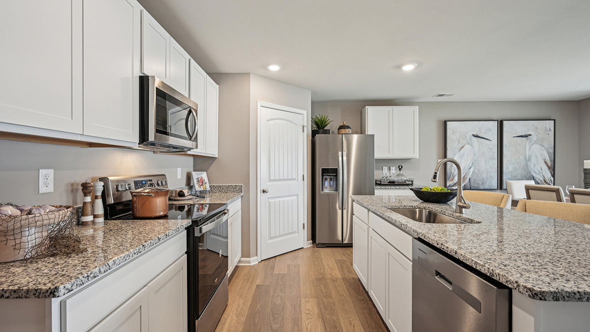 The kitchen includes stainless steel appliances.