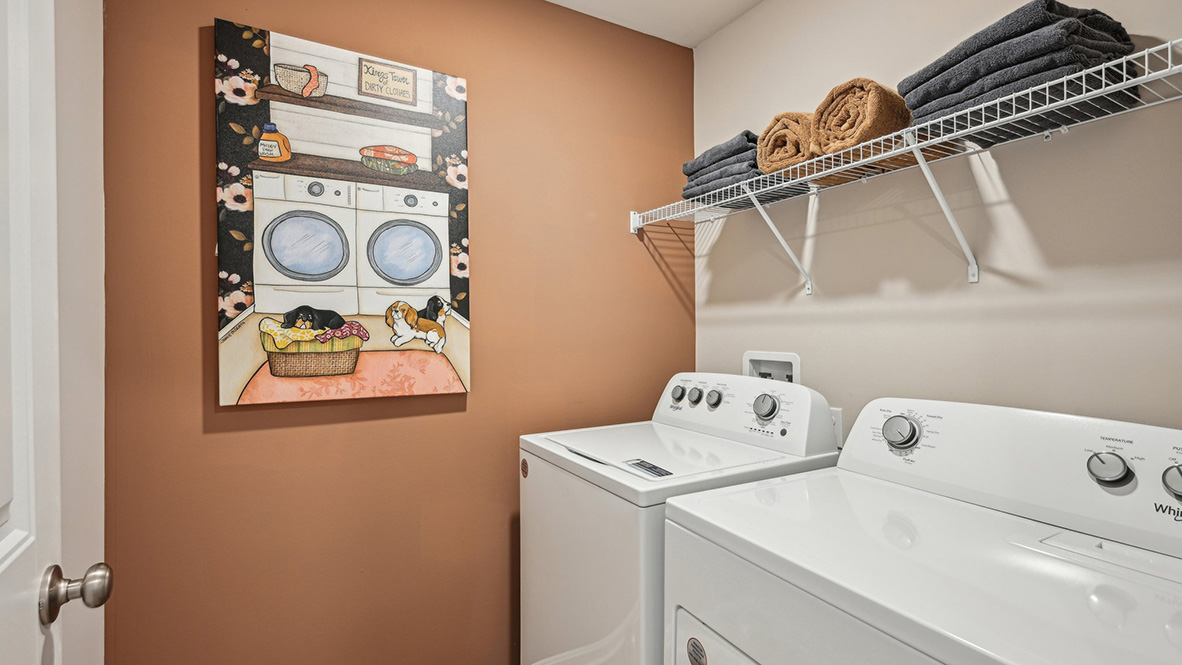 The laundry room comes complete with a washer and dryer.