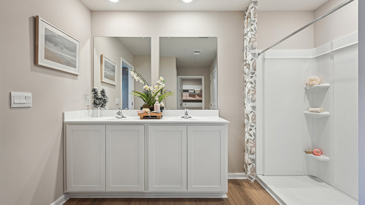The primary bathroom has a double-bowl vanity.