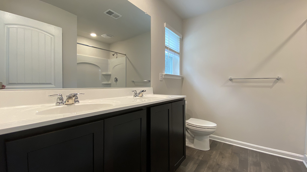 There is a private bathroom in the owner's suite with a double-bowl vanity.