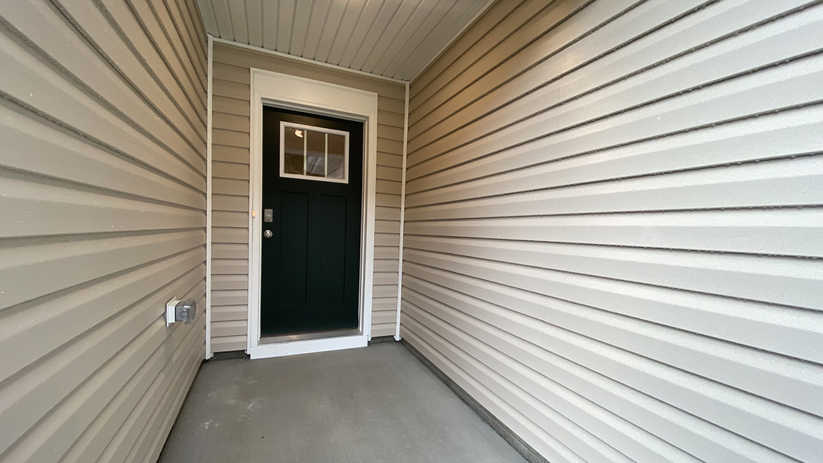 A covered entry leads you into this home.