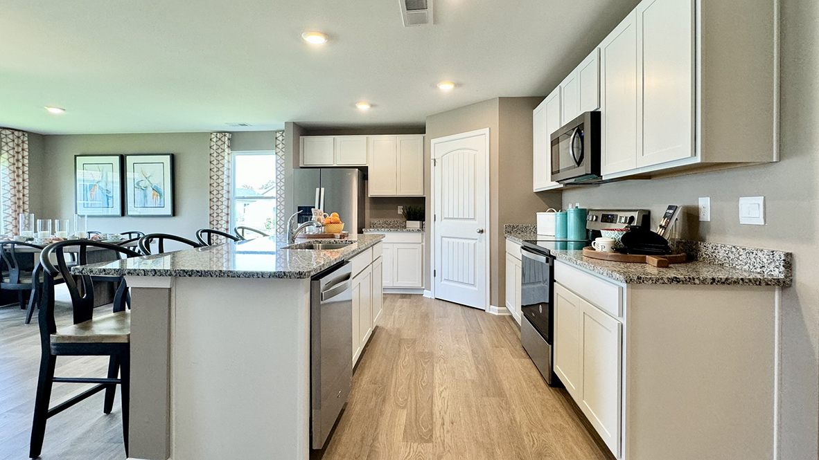 The Neuville's well-appointed kitchen features upgraded countertops.