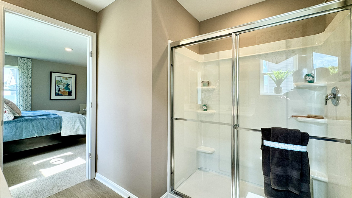 The owner's suite includes a private, full bathroom with a walk-in shower.