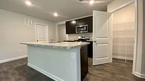 The home's well-designed kitchen offers a generous corner pantry.