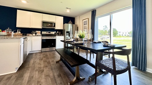 The kitchen is large enough for a dining room table.