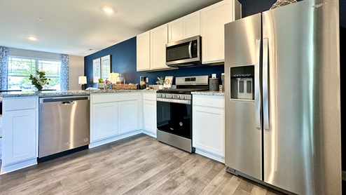 The functional kitchen offers modern cabinet space.