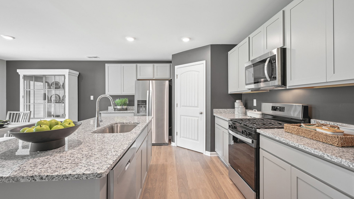 The kitchen includes a large center island with a sink.