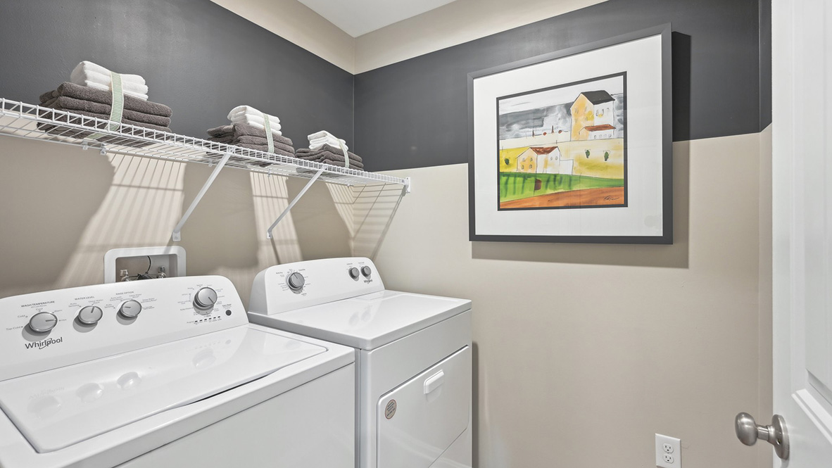 The laundry room is next to the fourth bedroom.