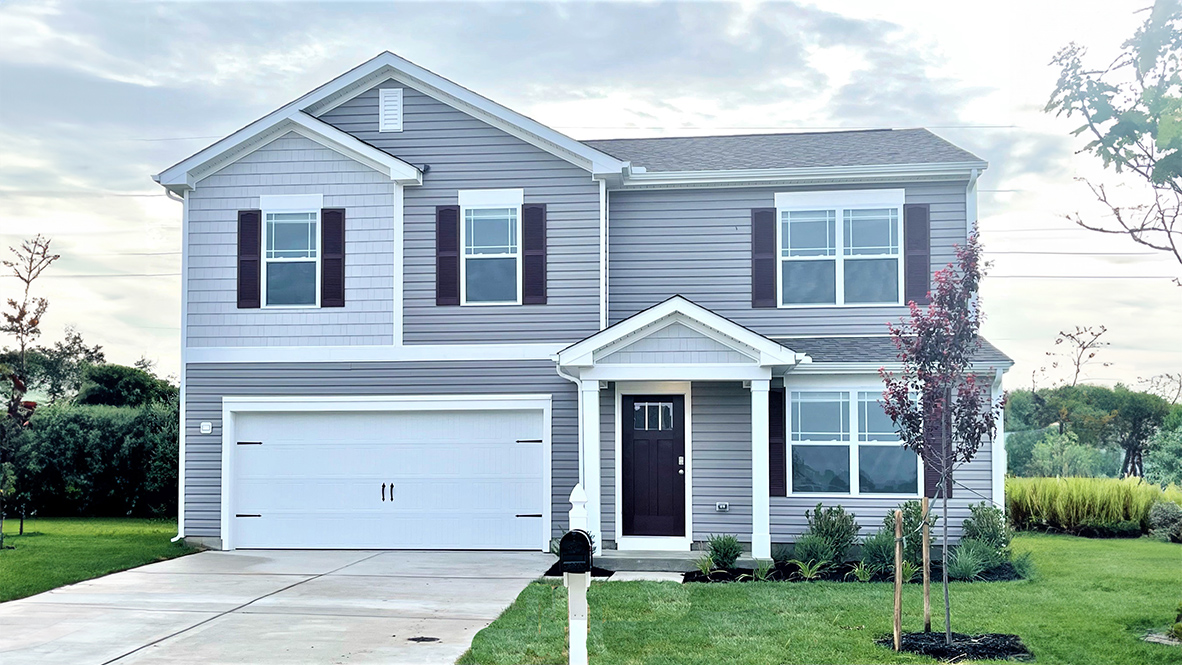 A two-story Glendale home with tan siding and brown shutters.