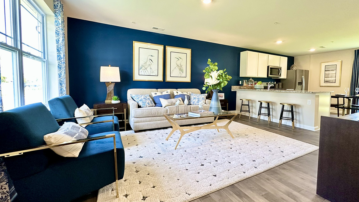 Living area that opens into the kitchen with granite countertops.