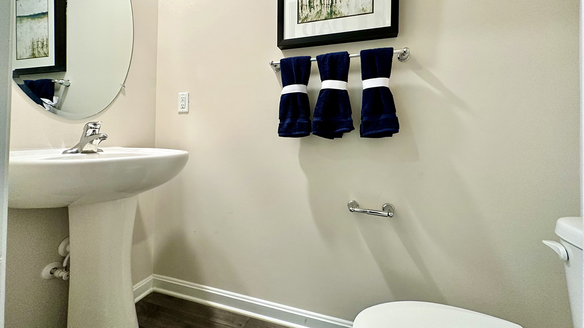 A powder room is located down the hall from the kitchen.