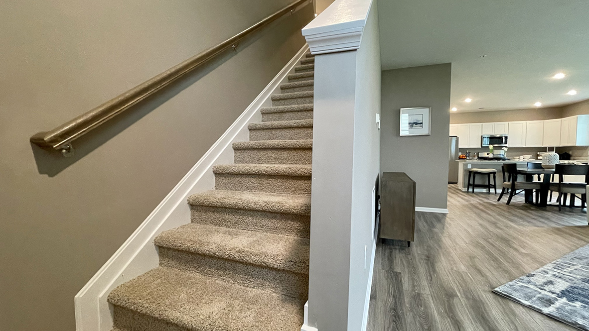 The stairs are located in the corner of the family room.