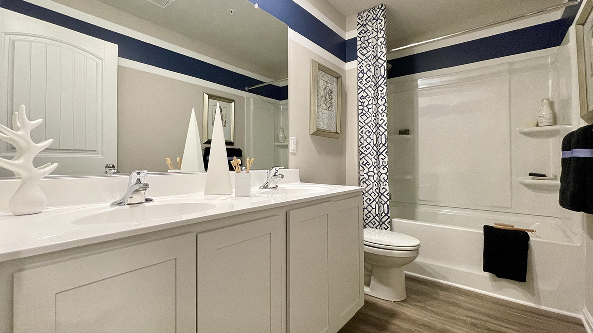 The guest bathroom has a double-bowl vanity.