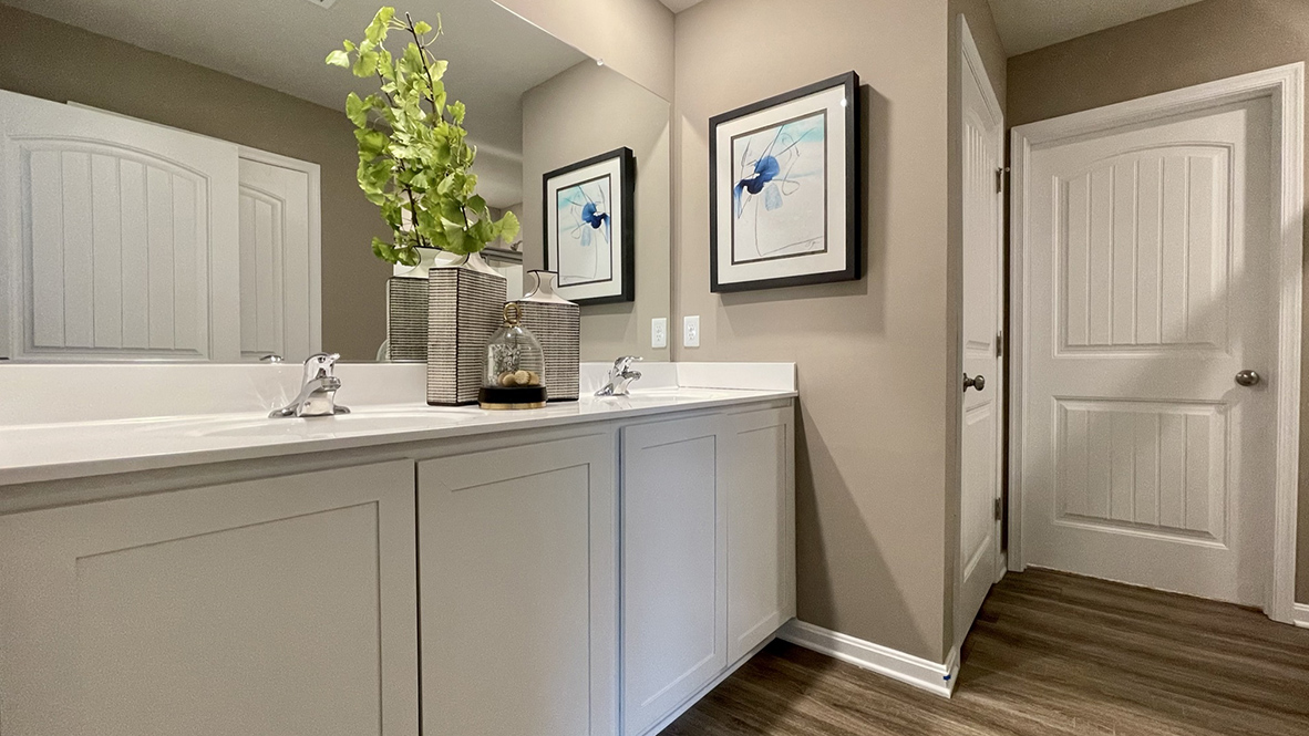 The oversized owner’s bathroom has a double-bowl vanity with a linen closet.