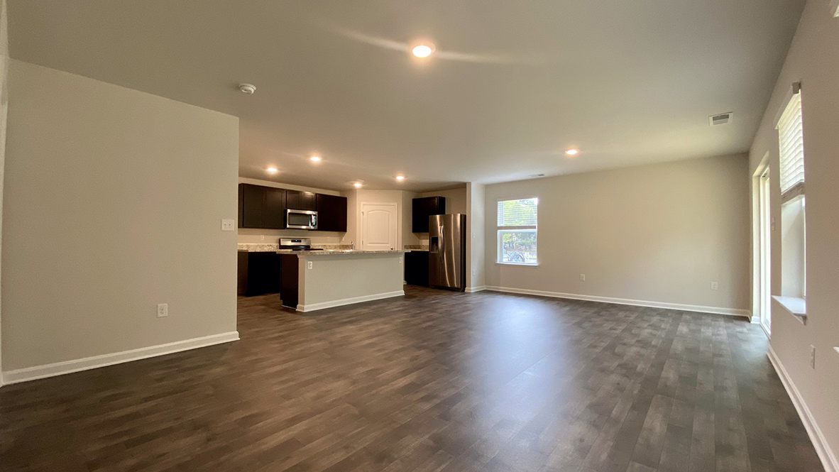 The ample great room and dining area both offer an abundance of natural light.