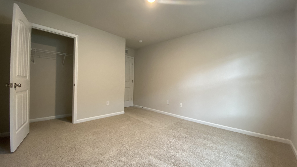 A spacious guest bedroom with a closet is in the front of the home.