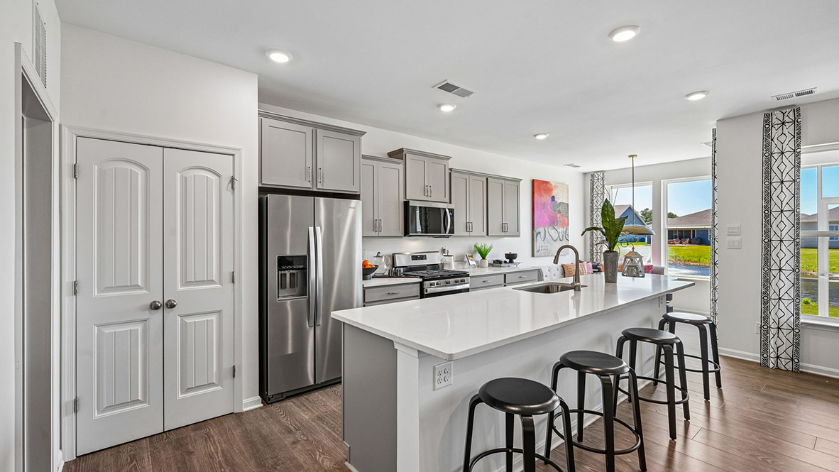 The open floorplan features a well-designed kitchen complete with an oversized island.
