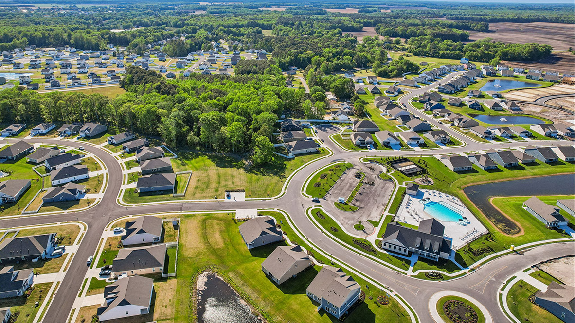 An aerial photograph of the clubhouse, pool, and pickleball courts.