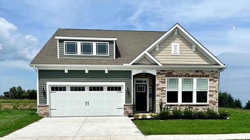 Coastal Villages Azalea home with a stone front.