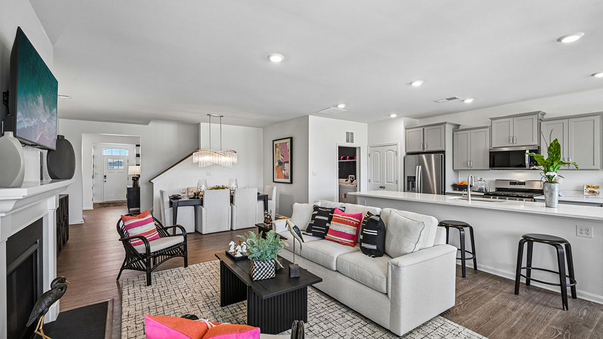 The open floorplan features a well-designed kitchen complete with stainless steel appliances.