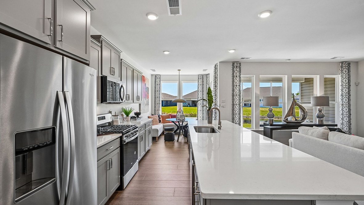 The open floorplan features a well-designed kitchen complete with an oversized island.