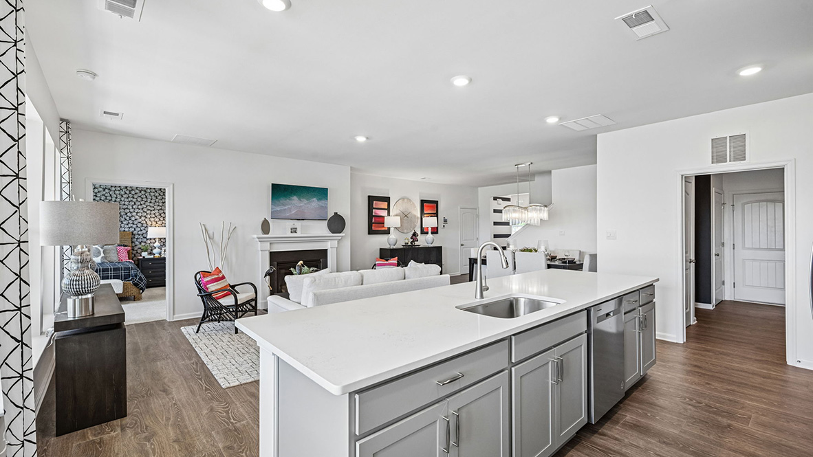 The open floorplan features a well-designed kitchen complete with an oversized island.