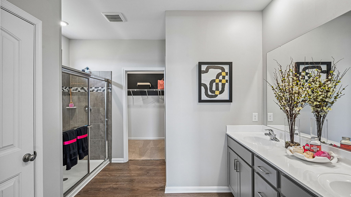 The spacious bathroom with a luxury shower has a large walk-in closet.
