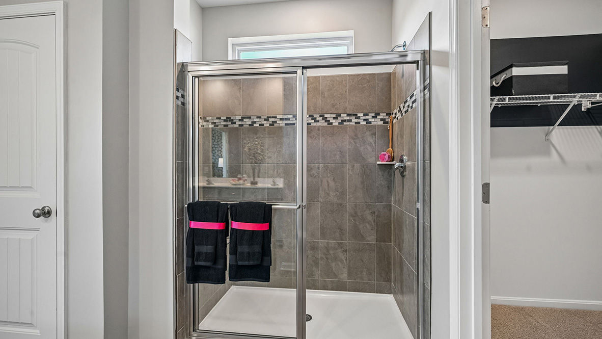 The private owner’s suite is a retreat in the back of the home with a spacious bathroom with a luxury shower.