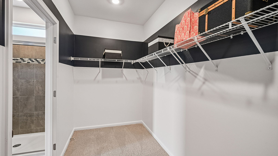 The spacious bathroom with a luxury shower has a large walk-in closet.