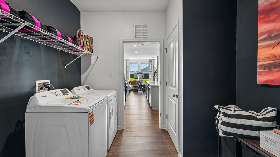 The large laundry room, tucked between the kitchen and the two-car garage.