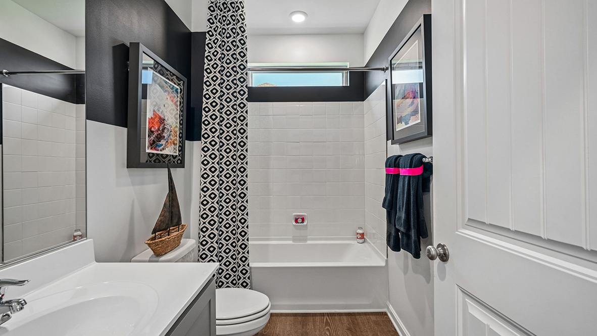 The welcoming foyer separates to afford privacy to the secondary bathroom.