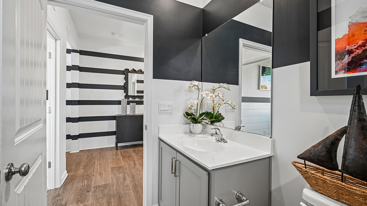 The welcoming foyer separates to afford privacy to the secondary bathroom.