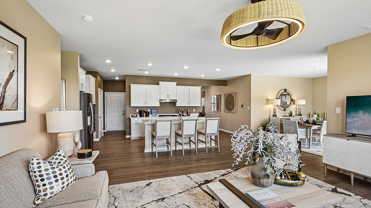 Featuring plank flooring, the kitchen is open to the living room.