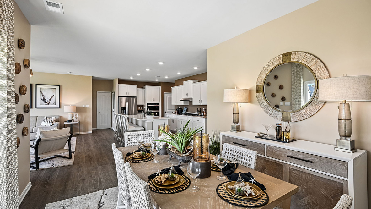 Featuring plank flooring, the kitchen is open to the dining room.