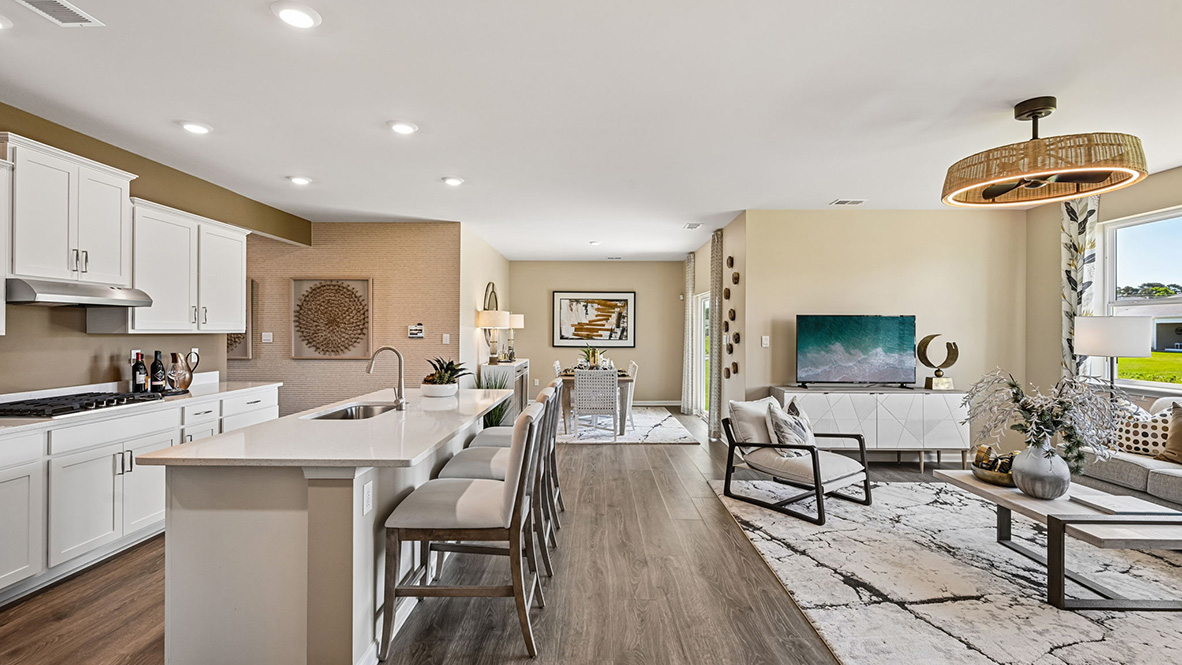 Featuring plank flooring, the kitchen is open to the living room.