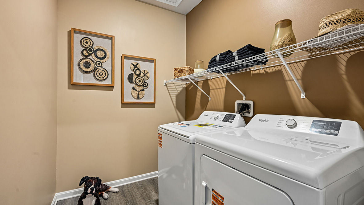 The laundry room is tucked behind the kitchen.