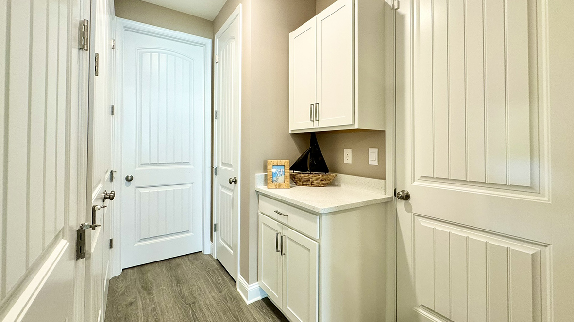 Tucked between the kitchen pantry and the three-car garage, features a coat closet and the laundry room.