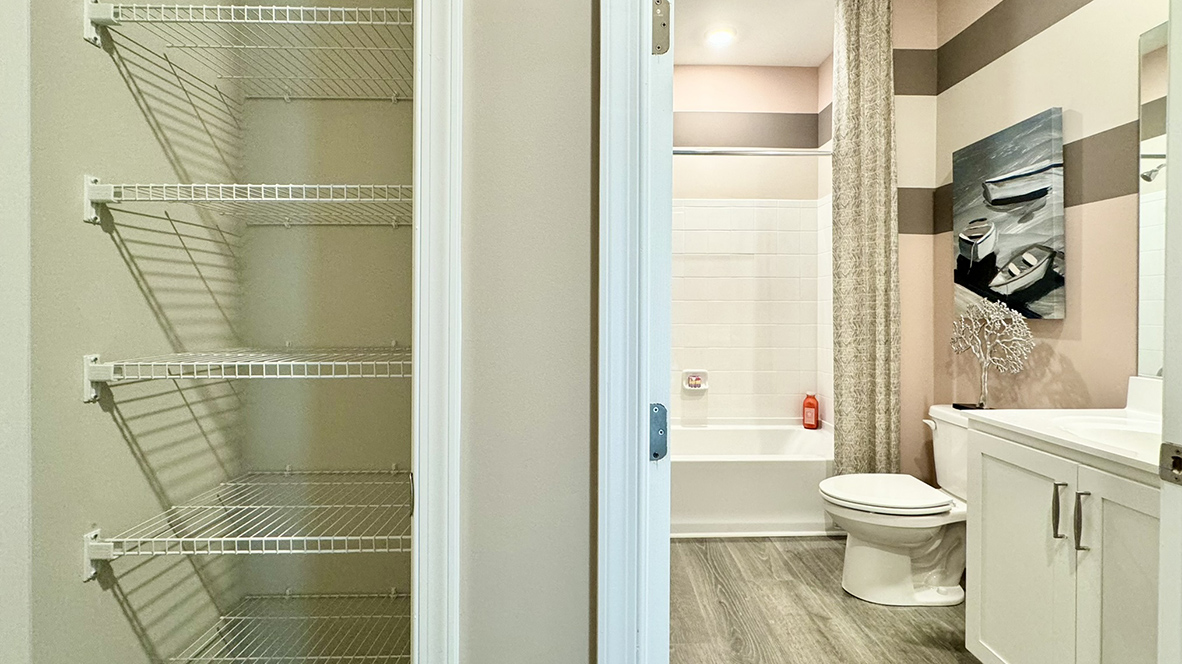 Hallway linen closet next to hallway bathroom.