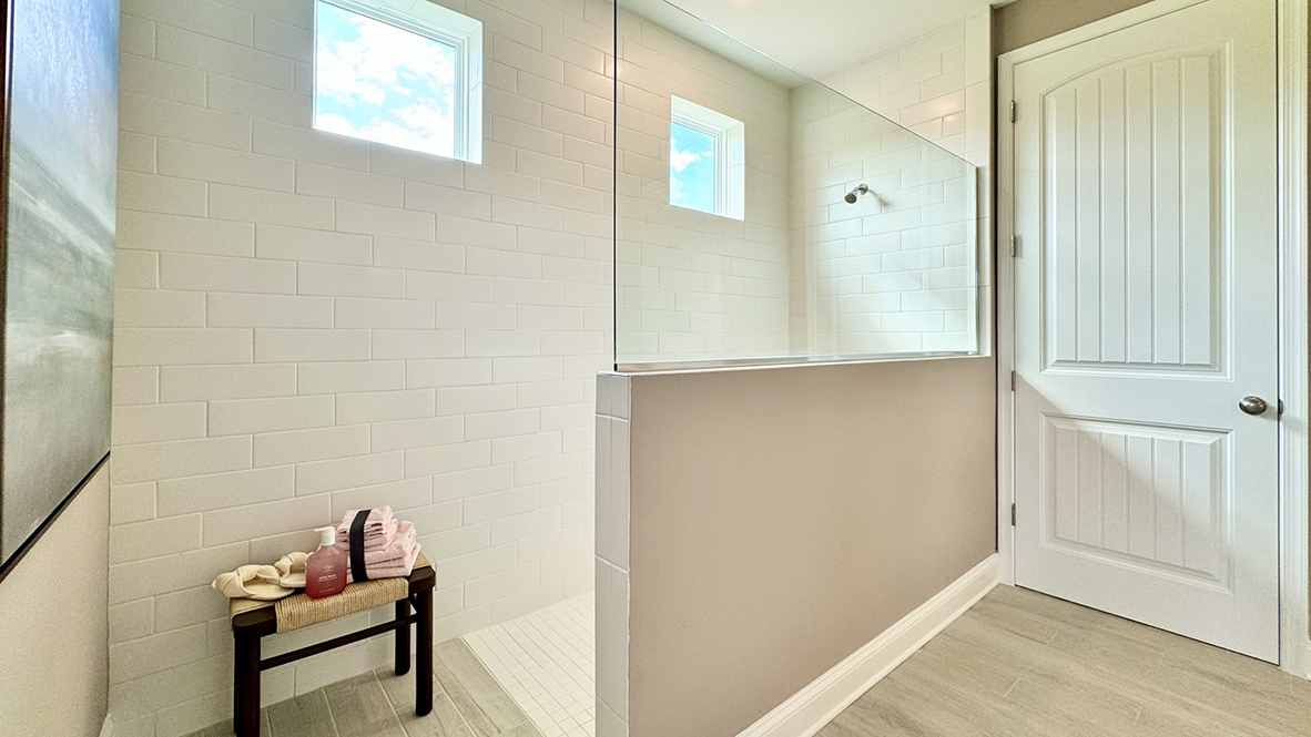 The primary bathroom has a large walk-in shower.