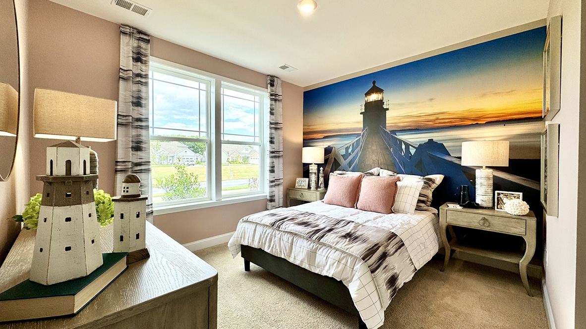 Guest bedroom with large windows.