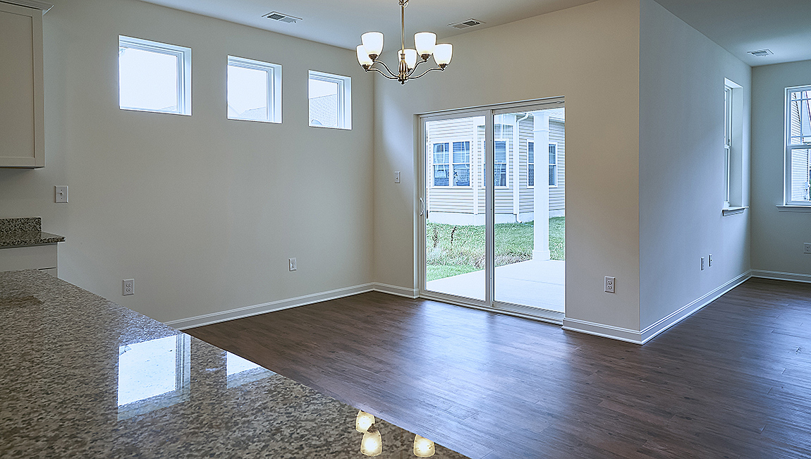 The open kitchen boasts a large island which opens into the large dining area.
