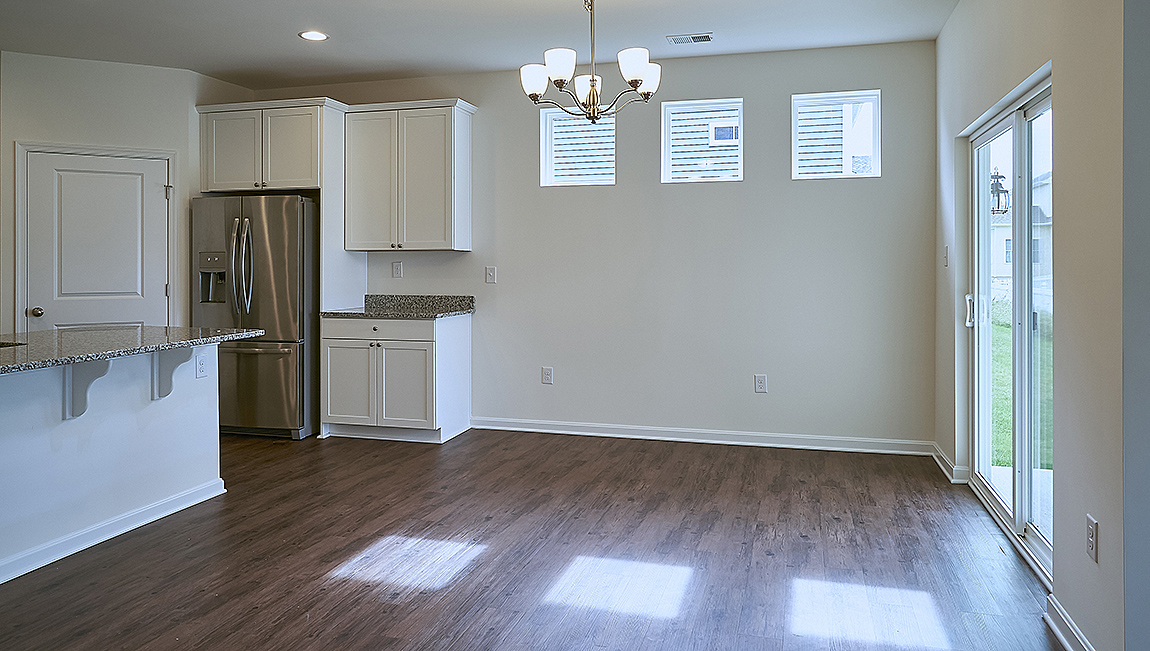 The open kitchen boasts a large island which opens into the large dining area.