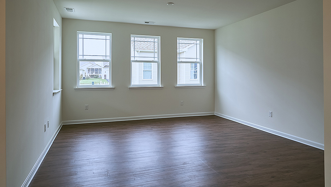 The open kitchen boasts a large island which opens into the large living area.