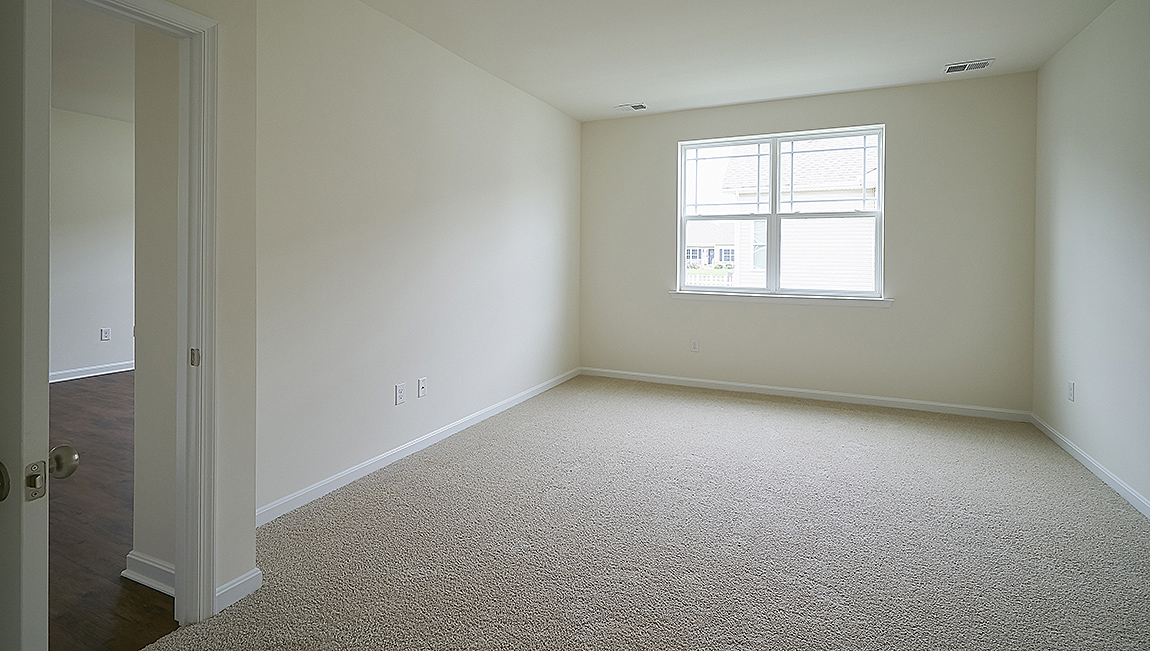 The owner’s suite with a private bathroom and a walk-in closet is a retreat in the back of the home.