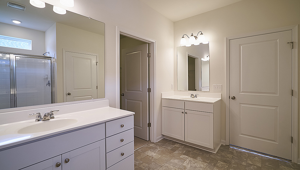 The owner’s suite with a private bathroom and a walk-in closet is a retreat in the back of the home.