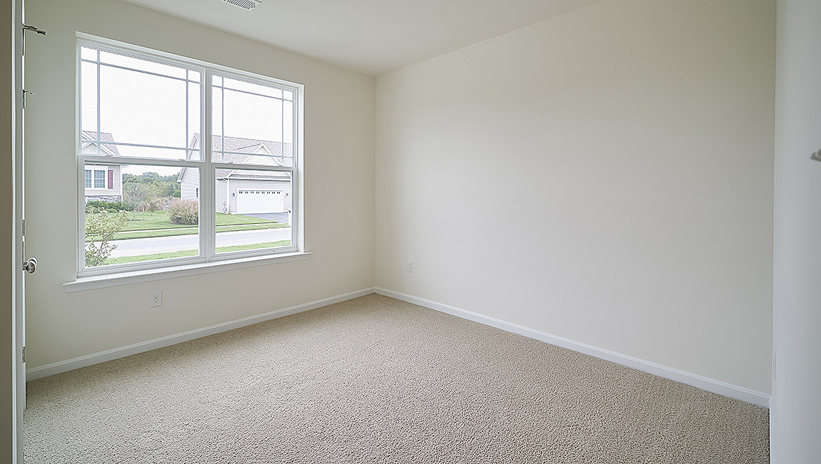 The guest bedrooms and the secondary bathroom are located near the front of the home.