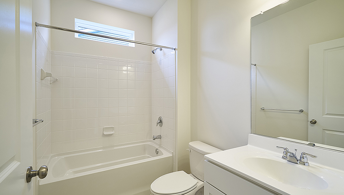 The guest bedrooms and the secondary bathroom are located near the front of the home.